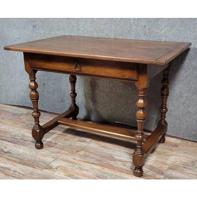 Louis XIII style solid walnut table or desk, circa 1850. Features one drawer in the apron. Turned legs with a stretcher...