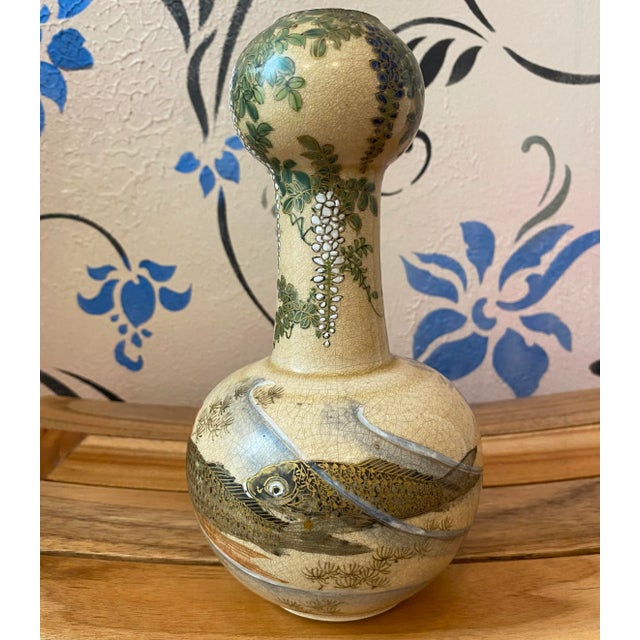 This charming satsuma vase has three fish and signature on the bottom in red. There is a removable cork near the bottom....