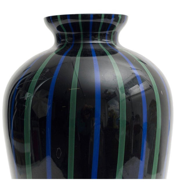 Beautiful Murano glass vase. The vase is black decorated with green and blue vertical lines. Created in 1970s. Very good...