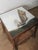 This charming antique oak side table features a unique hand-painted tile top depicting a nautical sailing scene—a...