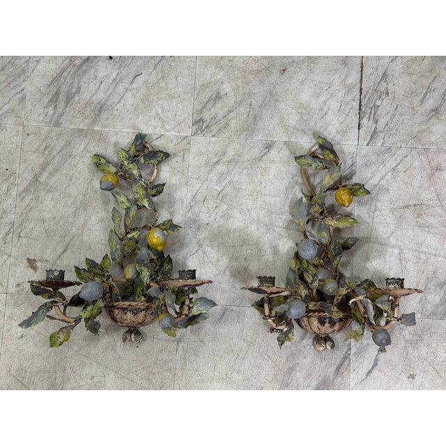 Wonderful pair of vintage Italian tole wall sconces, intricately fashioned with climbing branches of leaves and...