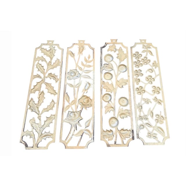 Elegant set of four mid-century gilt metal botanical wall plaques by the Sexton Company of Chicago, each measuring 20...