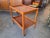 Bring timeless Scandinavian warmth and functionality into your home with this handsome Mid-Century Modern teak rolling bar...
