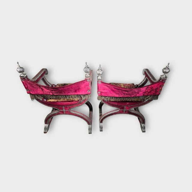 An important pair of 18th-century Mexican Colonial armchairs (jamugas), exquisitely crafted from silver, silk, and red...