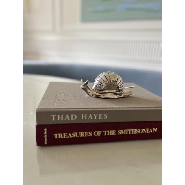 A charming silver plated vintage snail butter dish that brings a touch of whimsy and sophistication to the table....