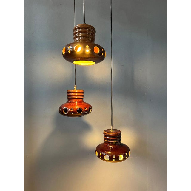 West Germany cascade chandelier with three ceramic lights. The height of each individual light can easily be adjusted, the...