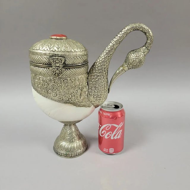 A wonderful Anglo-Indian hand hammered silver and nautilus shell bird container. Inspired by British Colonial objects,...