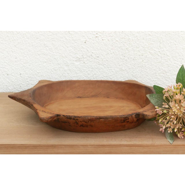 The sculptural form of this vintage bowl takes center stage. Carved from a single piece of solid hardwood, it features a...