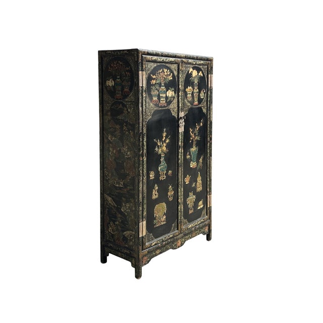 This striking vintage Oriental cabinet features a rich black lacquer finish, serving as a dramatic canvas for its...