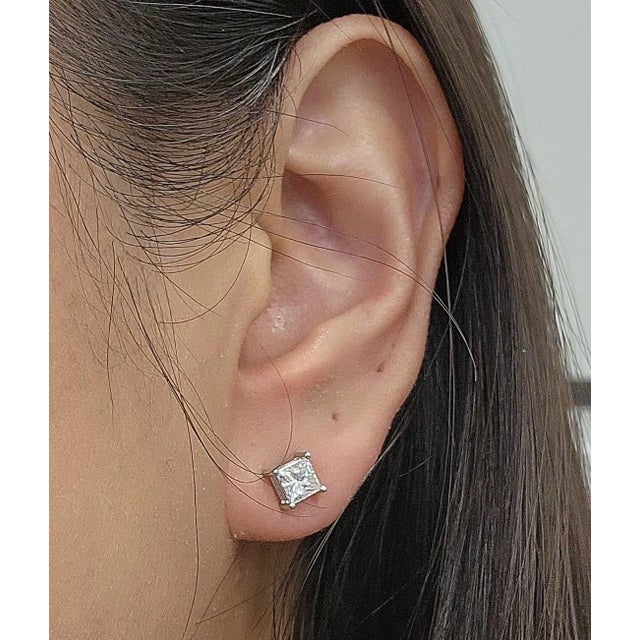 These exquisite stud earrings feature approximately 1.00 ct princess-cut white diamonds. The diamonds are E/F in color and...