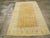 A vintage Indian Cotton Agra rug. A Mughal style lattice displays simple yellow palmettes on the medium brown, variegated...