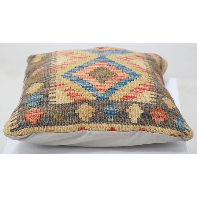 A one-of-a-kind handwoven Afghan wool kilim accent pillow featuring twin blue medallion diamonds with a banded border. Cut...