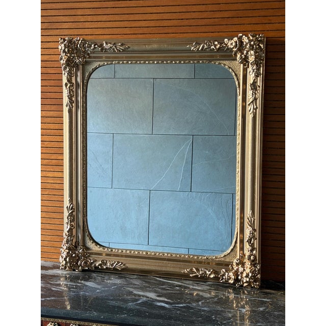Elegant French decorative mirror in a richly carved wooden frame, dating from the late 19th century. The frame features...