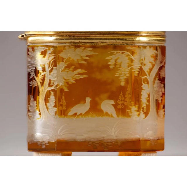 Small bohemian yellow crystal jewelry box decorated with hunting scenes of deer, birds and greyhounds in nature, all...