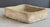 A rustic English garden sink or trough of composition stone, featuring a walled rectangular body with two holes in the...