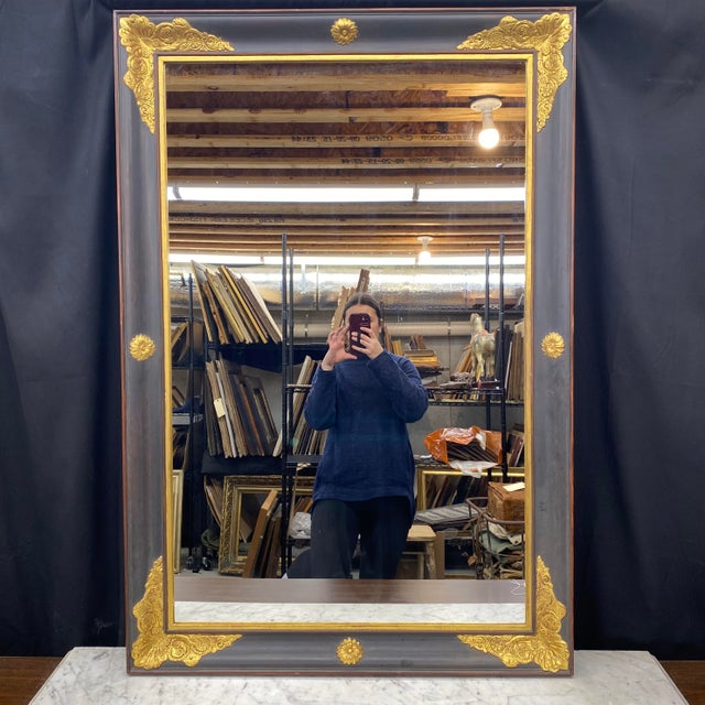 Large scale Empire gold gilt and ebony black mirror is a large statement piece. The giltwood finish is complemented by a...