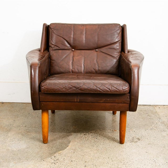Outstanding top grain brown leather wingback lounge chair on 4 solid wood legs. This piece comes in a rich and high...