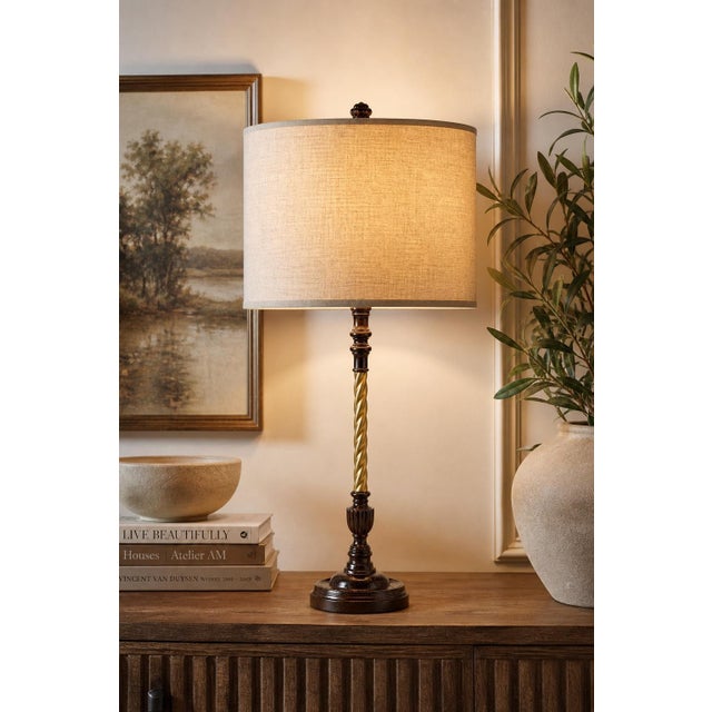 A striking vintage table lamp refinished in a rich walnut tone with a contrasting aged gold twist column and tailored...