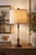 A striking vintage table lamp refinished in a rich walnut tone with a contrasting aged gold twist column and tailored...