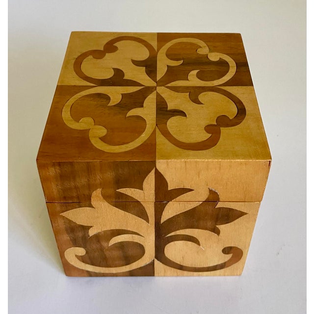 Here is a lovely lidded wood box, that features designs with inlay wood in a blonde and walnut wood species/finish. The...