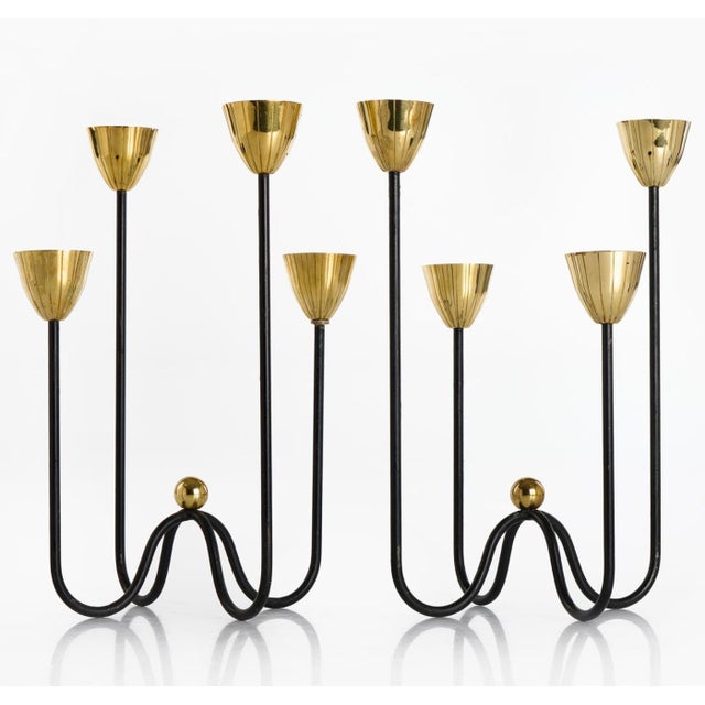 A pair of candleholders by GUNNAR ANDER for Ystad Metall, 1950s. Black lacquered metal and polished brass.