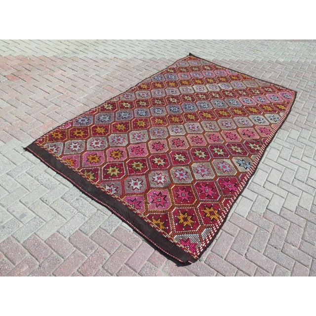 This beautiful, traditional vintage, flatweaved Turkish kilim rug is approximately 60 years old. It is handmade of very...
