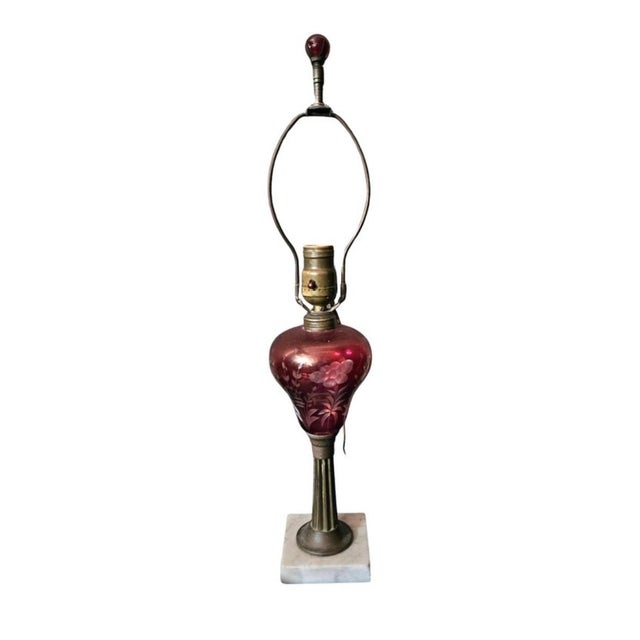 An Early 20th Century Marble and Cranberry Glass Table Lamp with original harp and finial. Measures 4" in width, 4" in...