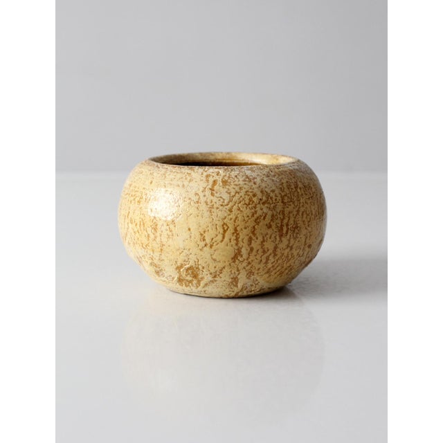 Vintage Mexican pottery planter with a low, rounded silhouette and a softly textured surface in warm cream tones. Hand-...