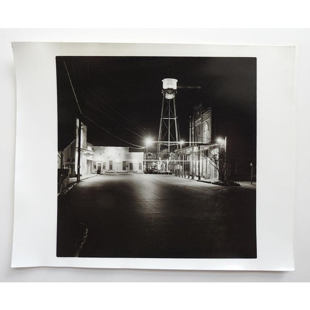 Late 20th century black and white photograph of water tower and downtown Greune Texas at night by Eric C. Weller (20th...