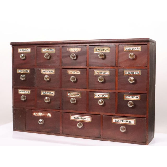 Antique tabletop apothecary storage cabinet with a dark stain mahogany front. This was used by pharmacists to store raw...
