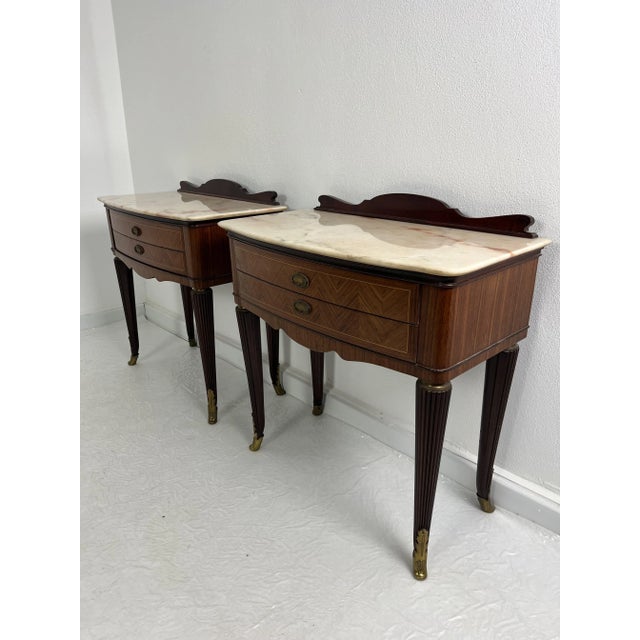 Set of two mid-century Italian bedside tables, 1950s Intact and in good condition. Brass feet, marble top. Two drawers on...