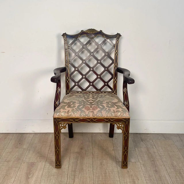 A pair of matching Chinese Chippendale armchairs with blind fretwork and gilt highlights. Seat height 19.75".