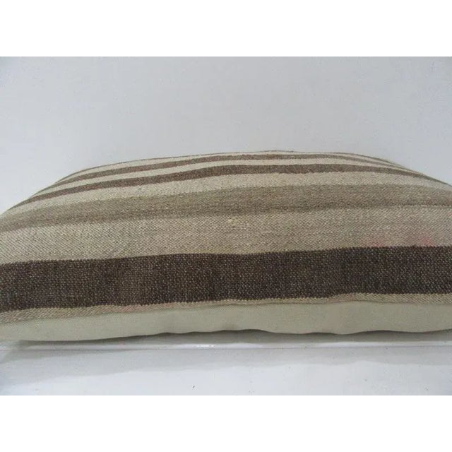 This is a pillow cover made from a vintage kilim rug. The piece was properly washed and ready to use. Pillow inserts not...