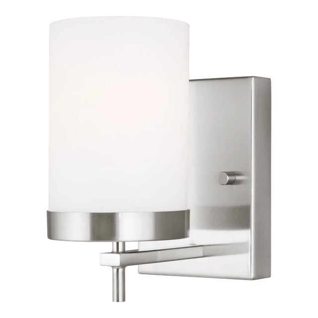 The Zire one light wall sconce in brushed nickel provides abundant light for your bath vanity, while adding a layer of...