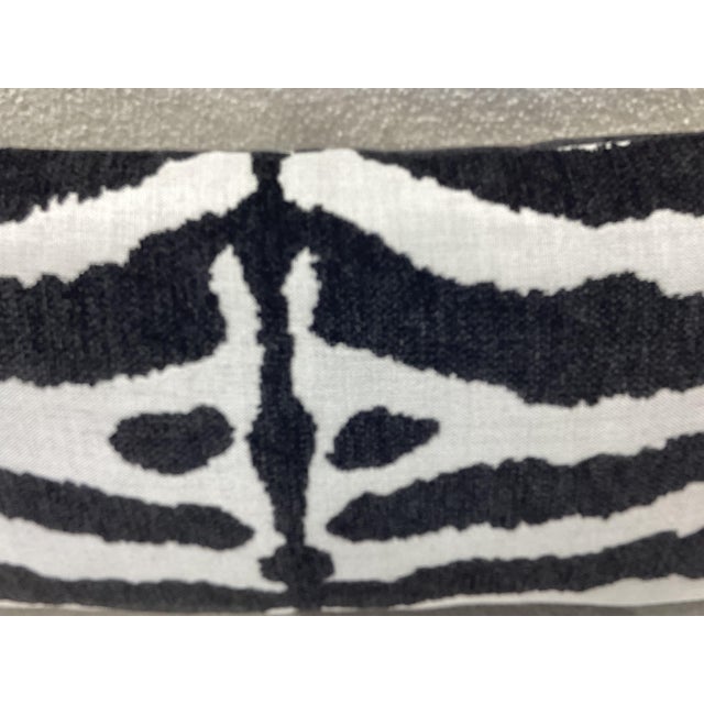 Black and ivory Chenille style weave fabric, knife edge, pillow with a striking zebra inspired pattern. It is soft, plush...
