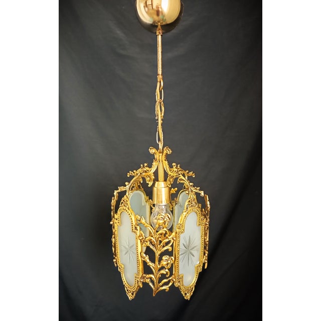 Vintage 1960s brass chandelier with its original finish, elegant floral details and classic European design....