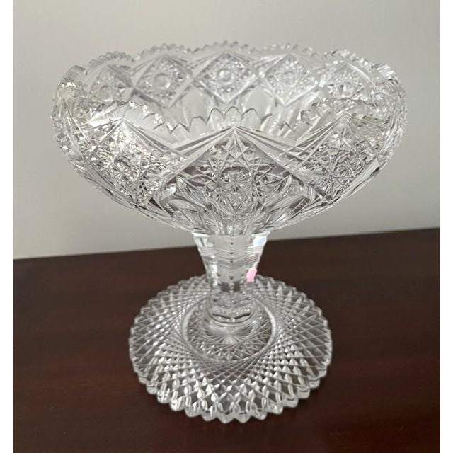 8" high American Brilliant period cut crystal footed bowl/compote, late 19th century. It is decorated all over with a...