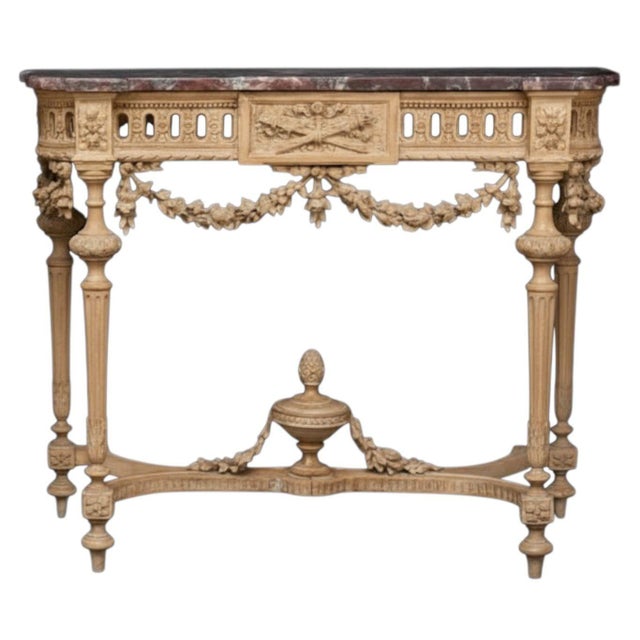 An impressive pair of French Louis XIV style console tables, richly carved and retaining their original conforming marble...