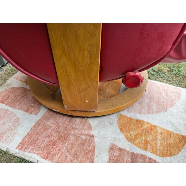 Details ChairWorks Red Leather Upholstered Reclining Swivel Armchair and Ottoman, circular tripod bases, each labeled...