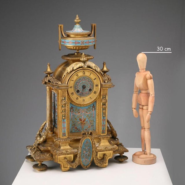 Gilded bronze table clock with cloisonné enamel plates. Roman numeral dial and movement marked Charles Pickard Paris. This...