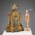 Gilded bronze table clock with cloisonné enamel plates. Roman numeral dial and movement marked Charles Pickard Paris. This...