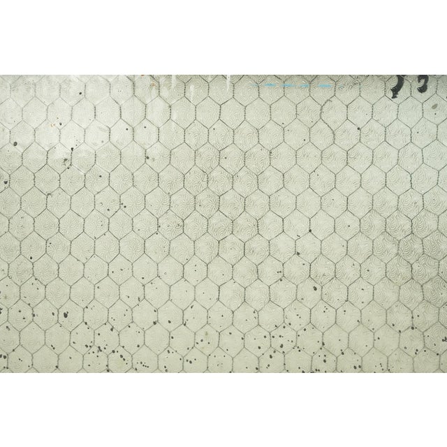 Reclaimed rectangular shaped window with a wood frame, steel sides, and a clear wormy chicken wire glass pane. It was...