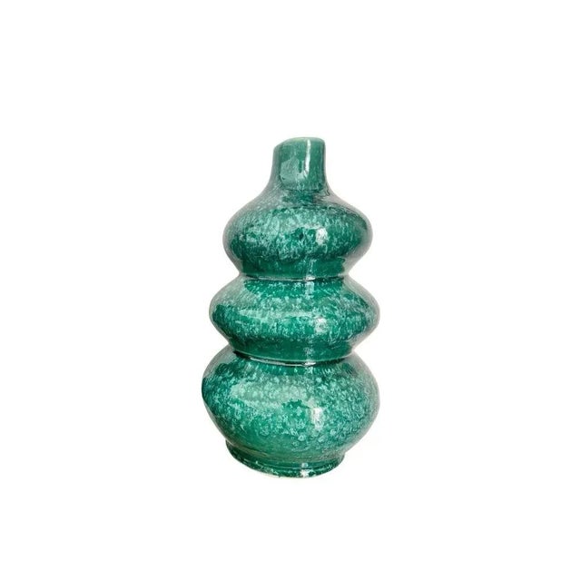 The rich and soothing shade of this vase adds a touch of freshness to your space. The painted finish gives a delicate...