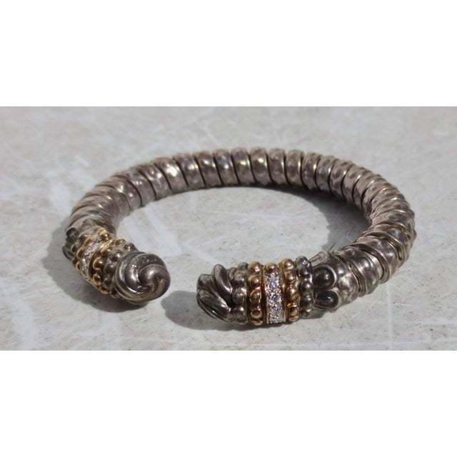 Bangle with 19 Diamonds, full cut, 14 kt. gold and Sterling. Circa 1970s. The weight is 27.1 dwt. Marked with trademark...