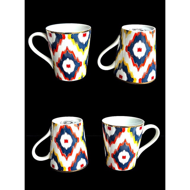 Offered is a set of Ikat patterned porcelain cups made for the store C Wonder. They feature bright navy, red, and yellow...