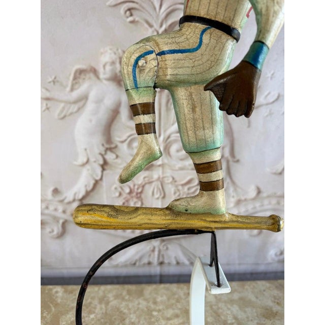 Whimsical and full of character, this charming vintage folk art kinetic sculpture depicts a baseball player balancing atop...