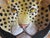 This is a Hollywood Regency Era Italian terracotta leopard bowl or plate. The edges are curved slightly. It has a vivid...