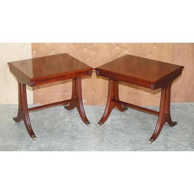 We are delighted to offer for sale this lovely pair of tables which have flamed mahogany tops and lions hairy paw brass...