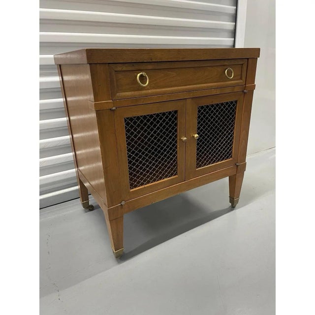 Offered is a vintage nightstand by Milling Road for Baker Furniture. This piece features one dovetailed smooth gliding...