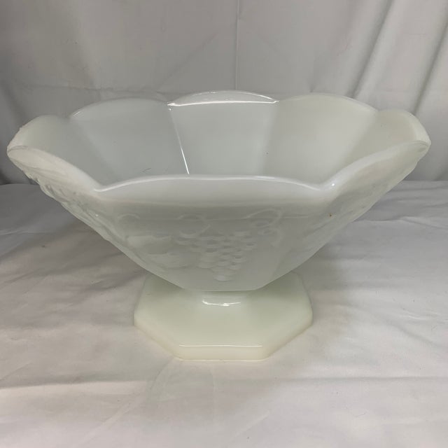 Offered here is a vintage Anchor Hocking Harvest Grape milk glass pedestal bowl featuring a paneled grapevine and leaf...